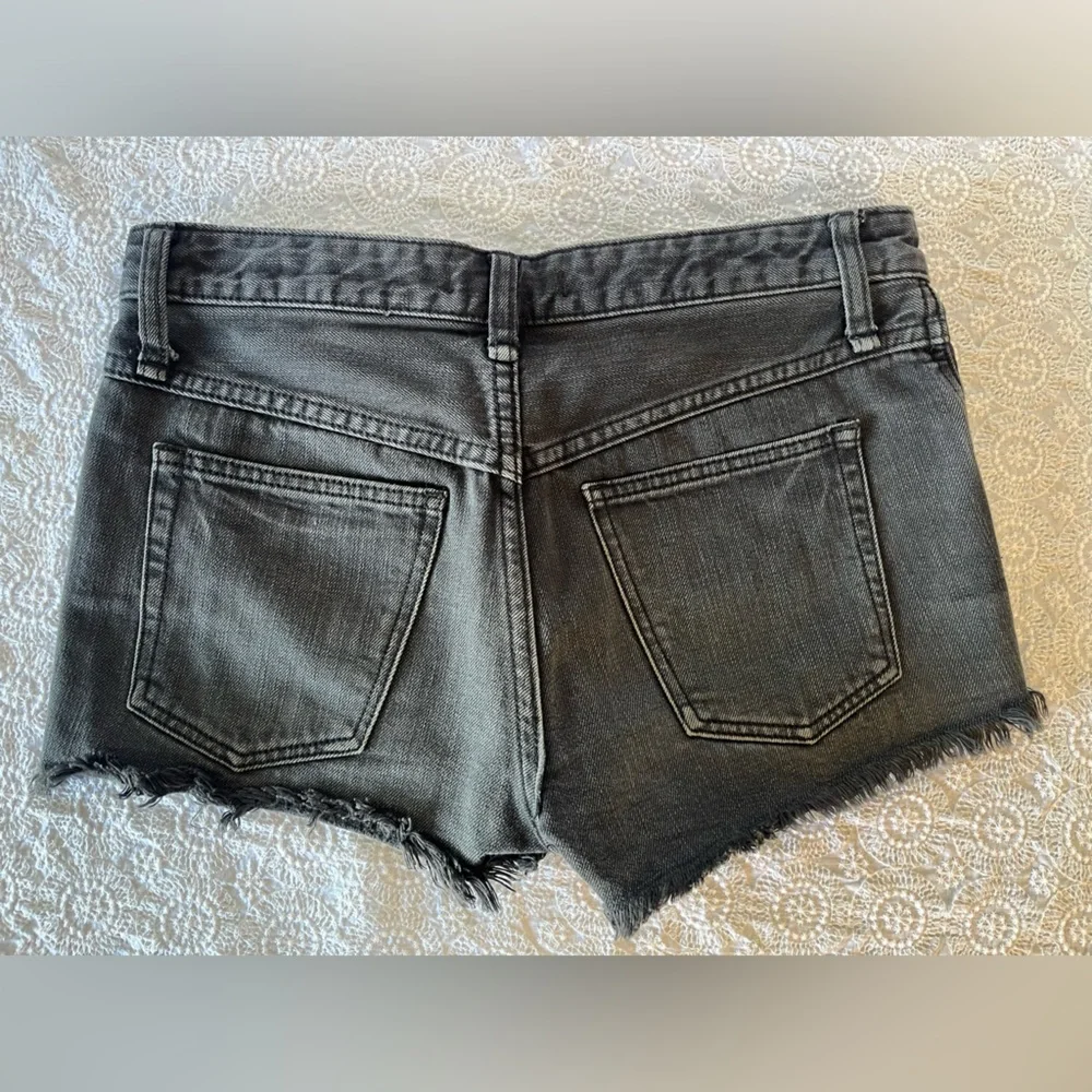 Free People black cut-off shorts, size 25; distressed black denim with raw hem